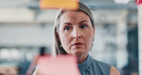 Woman Planning with Sticky Notes in Modern Office