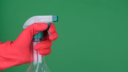 Hand with Red Glove Sprays Bottle on Green Screen