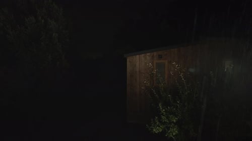 Wooden Cabins in Forest During Rainy Night