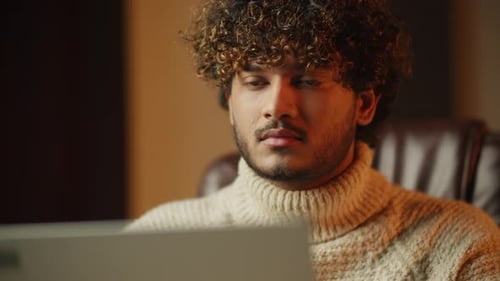 Young Adult Works on Computer at Night