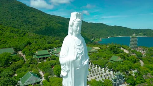 The Majestic Lady Buddha Statue Overlooks a Serene Coastal Landscape in Da Nang Surrounded By Lush