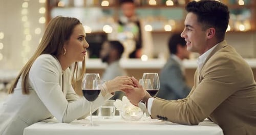 4k video footage of a happy young couple having a romantic date at a fancy restaurant