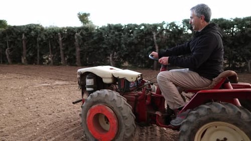 Man drives tractor on farmland
