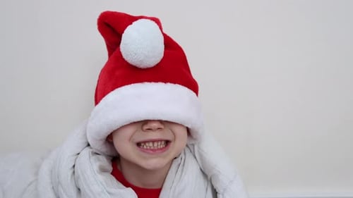 Smiling Child Wearing Christmas Santa Hat Indoors