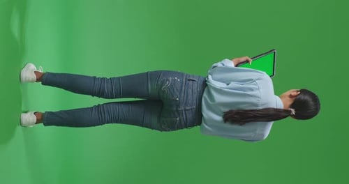Full Body Asian Business Woman Using Tablet With Mock Up Green Screen On Green Screen In The Studio