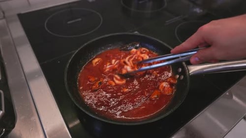 Italian Pasta Cooking Process with Seafood Cooked Pasta is Mixed with Sauce and Toppings in a Hot