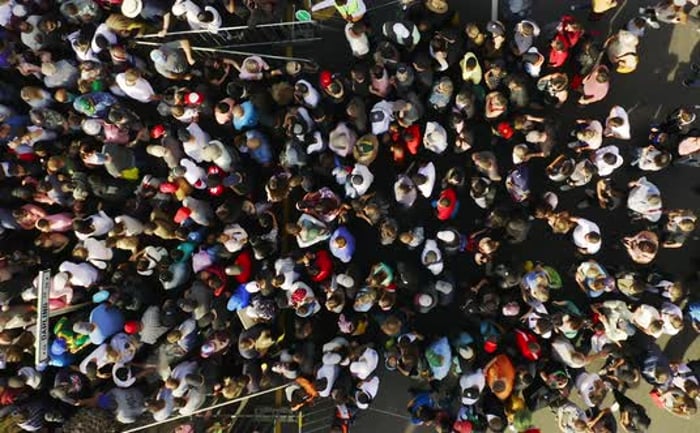 Aerial, crowd and group of people in city on street for concert, music ...