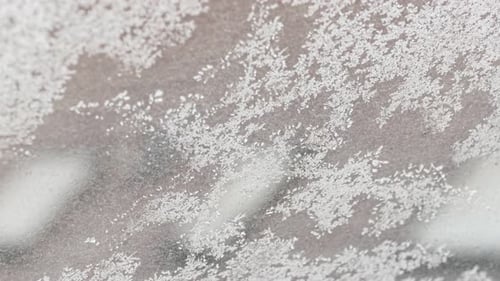 Snow Crystals on Glass in Close Up