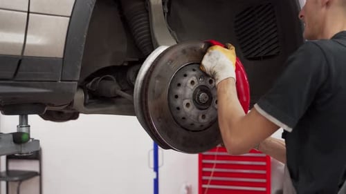 Auto Mechanic Replaces Disc Brakes and Pads at Car Service Technician Works on Vehicles Brake System
