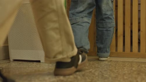 Guests Arrive Silently Adults and Children Walk Inside Footsteps Echo Across Tiled Room Floor