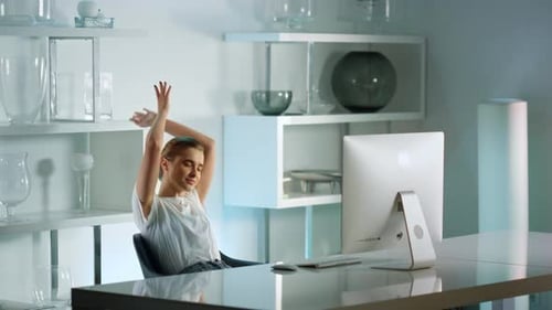Attractive businesswoman stretching body at home office after hard working day