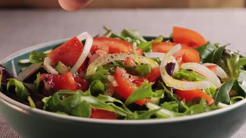 Pouring Olive Oil on Healthy Fresh Vegetables Vegan Salad Close Up Delicious Diet Salad of Tomato