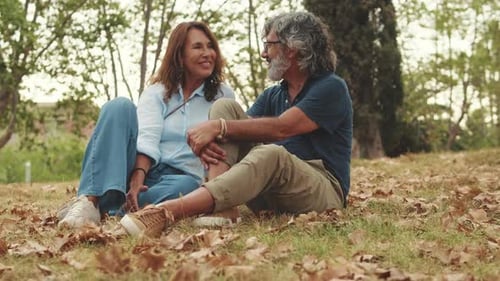 Mature Couple Talking Outdoors in an Autumn Park