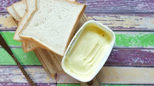 Fresh Bread and Butter on Wooden Table