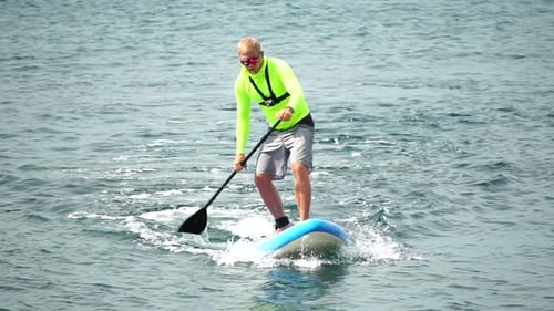 Man Sup Sea Strong Athletic Man Learns to Paddle Sup Standing on Board in Open Sea Ocean on Sunny