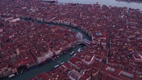 Aerial view of basilica, square, and canal at sunrise, Italy.