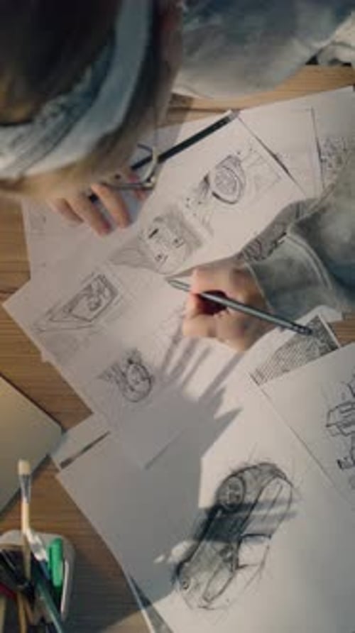 Young Woman Works on a Storyboard in a Design Studio Draws Sketch for the Videos