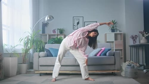 Home workout: woman stretching in cozy living room