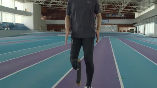 Man with Running Blade Training on Indoor Stadium