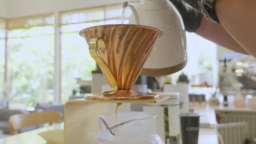Skilled barista pouring coffee indoor beverage preparation close-up artistry barista craft