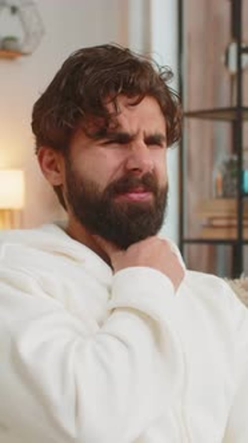 Man with Sore Throat Rubbing His Neck