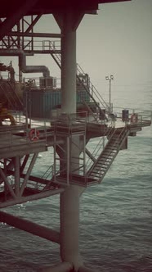 Giant Oil Rig Stands Tall Above Calm Ocean Waters in Soft Morning Light