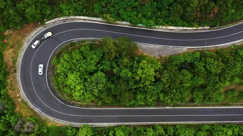 Aerial view of a cars on a road in the mountain