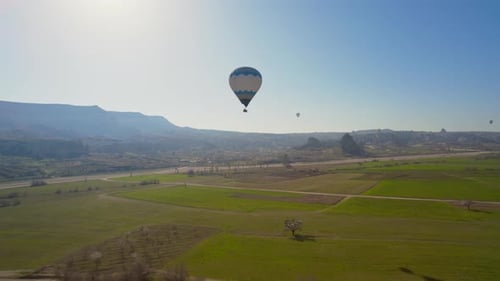 Scenic Hot Air Balloons Over Green Rural Landscape