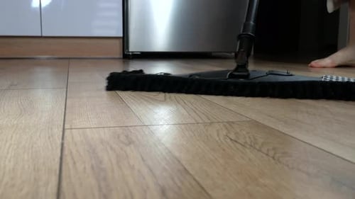 Woman cleaning and washing floor at home