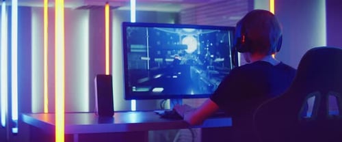 Gamer Playing Video Game in Neon Lit Room