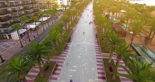 People walking on barcelona beach promenade.