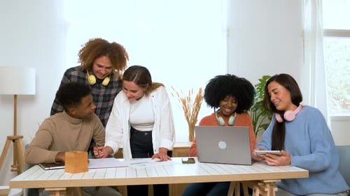 Diverse Young Adults Collaborating on Project at Home