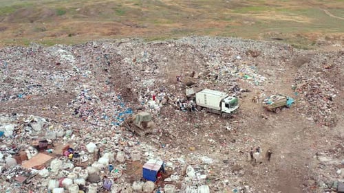Drone Aerial View of Large Landfill with Garbage Trucks and Waste Piles Environmental Pollution