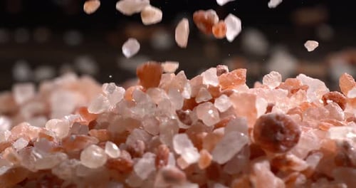 Himalayan pink salt in a super slow motion, natural mineral seasoning for healthy cooking and spa