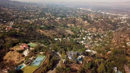 Upscale neighborhood with swimming pool and tennis field in San Fernando Valley. Sunny day with rich
