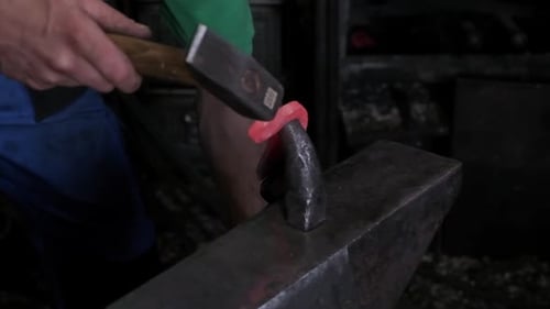 Blacksmith Hands Hammering Hot Glowing Steel on Anvil Closeup Traditional Metal Forging Workshop