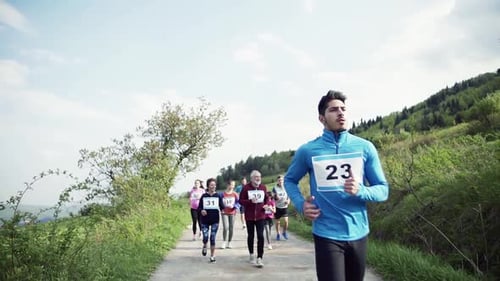 Group of People Running a Race on Path