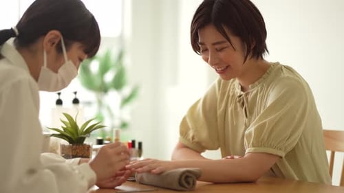 Woman Receiving Manicure at Nail Salon