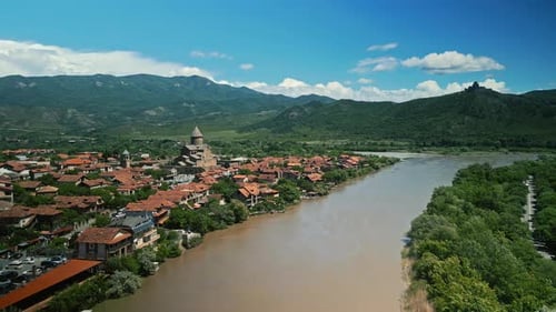 Aerial View of a Winding River Historic Svetitskhoveli Church and Mtskheta Town with Red Rooftops