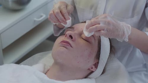 Woman Getting Facial Cleansing Treatment at Beauty Clinic