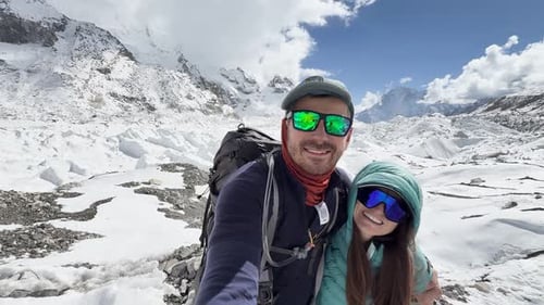 Happy couple at snowy Everest Base Camp in Himalayas, Nepal