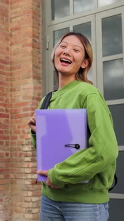 Vertical Portrait of a Young Asian High School Student Girl Smiling and Looking at Camera Chinese