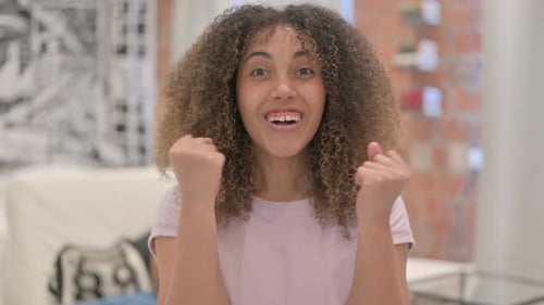 Portrait of Excited African American Woman Celebrating Success