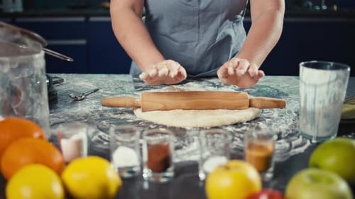 Woman Rolling Dough in Kitchen with Fruit