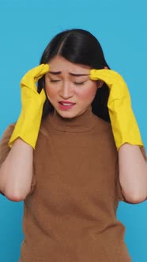 Vertical Video Overwhelmed Housekeeper Being Tired After Cleaning All House Using Variety of