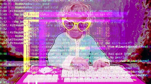 Child Typing on Keyboard Wearing Heart-Shaped Glasses