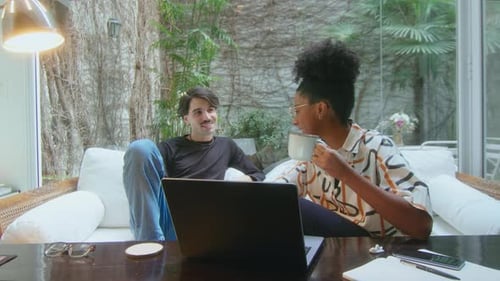 Young Adults Work on a Laptop at Home