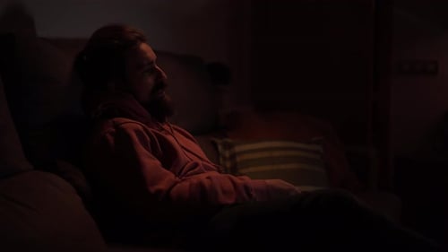 Caucasian Man Beard Sitting Quiet on Sofa Changing Channel TV Remote Control Male at Night Home