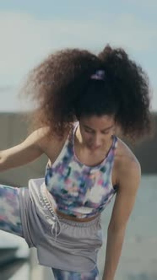 Woman Stretches Against Gray Wall Urban Setting