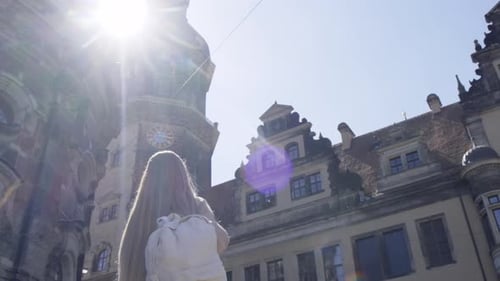 A Beautiful Tourist Girl Walks with a Backpack in the European City of Dresden Germany